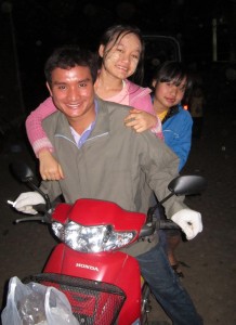 Stle Lin Shwe and his sisters Neh Blu Htoo and Hser Nay Say on a motorbike.